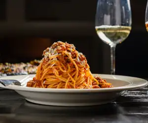Greca Bolognese: traditional meat sauce with tomato, spices and mizithra cheese.