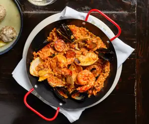 Greca's signature paella, with shrimp, mussels, clams, loukaniko and steak